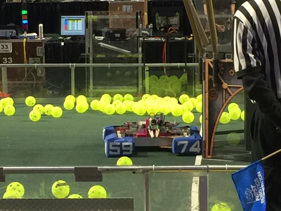 A picture of the 2017 robot playing on the field at the 2017 competition
